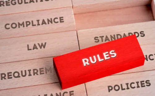 Wooden blocks labelled rules, compliance, law, standards and policies